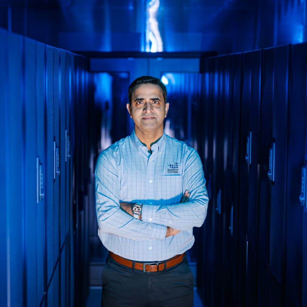 Salman Maqsood posing in the Saltech server room